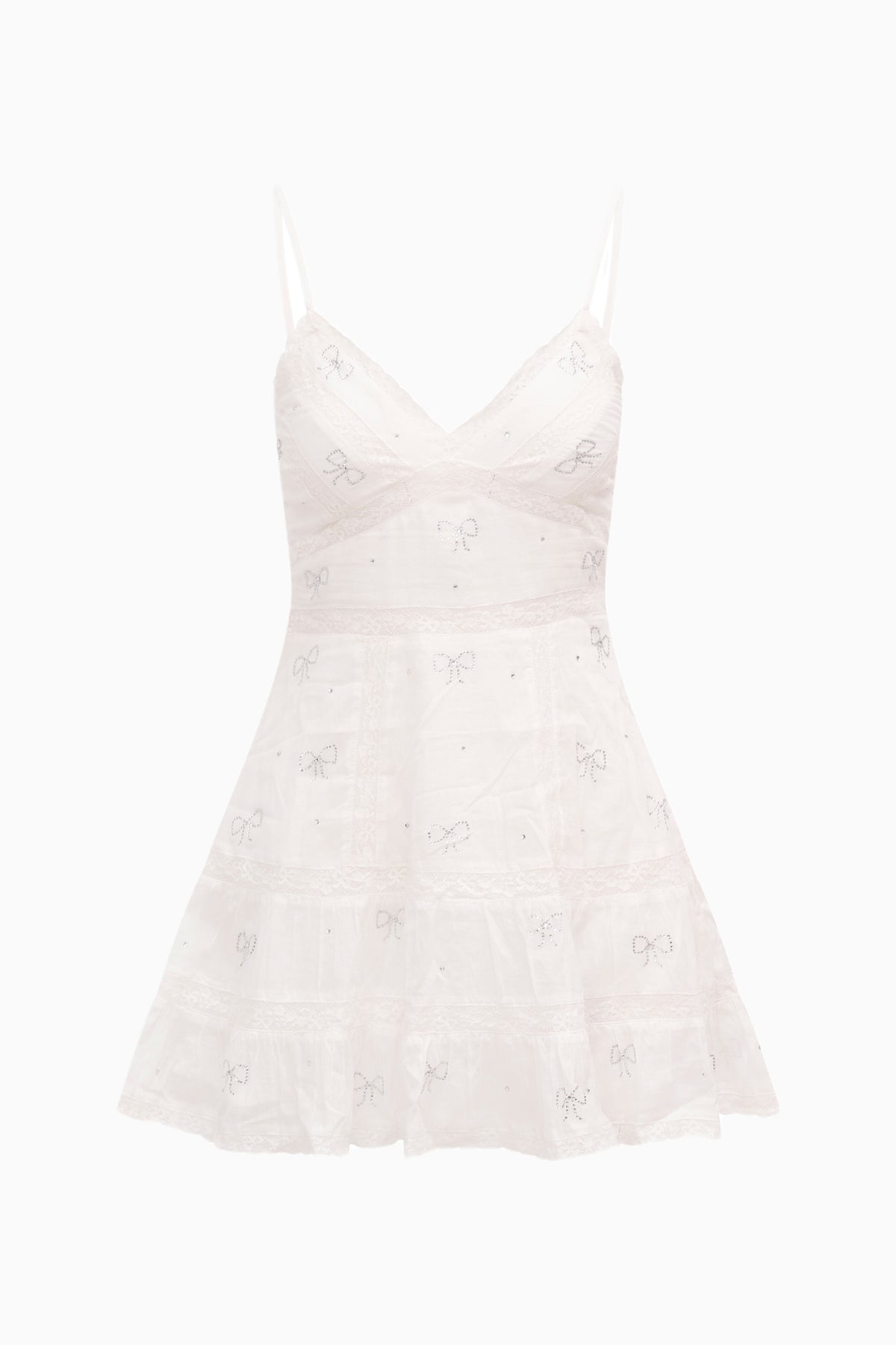 White cotton mini dress with thin spaghetti straps and tiered skirt, all-over bow motifs