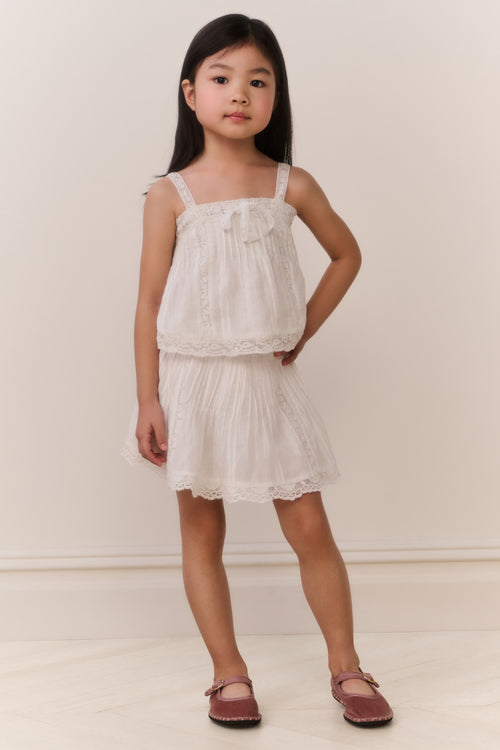 White cotton skirt with tiered ruffles and scalloped lace-trim hem