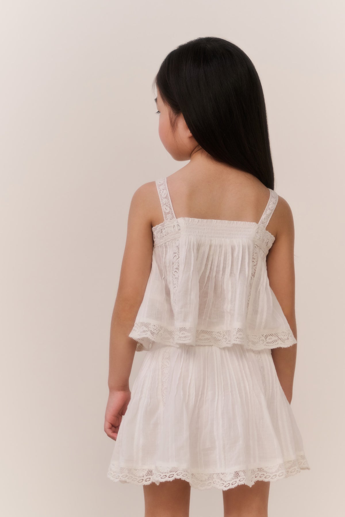 White cotton skirt with gathered tiers and scalloped lace-trim hem