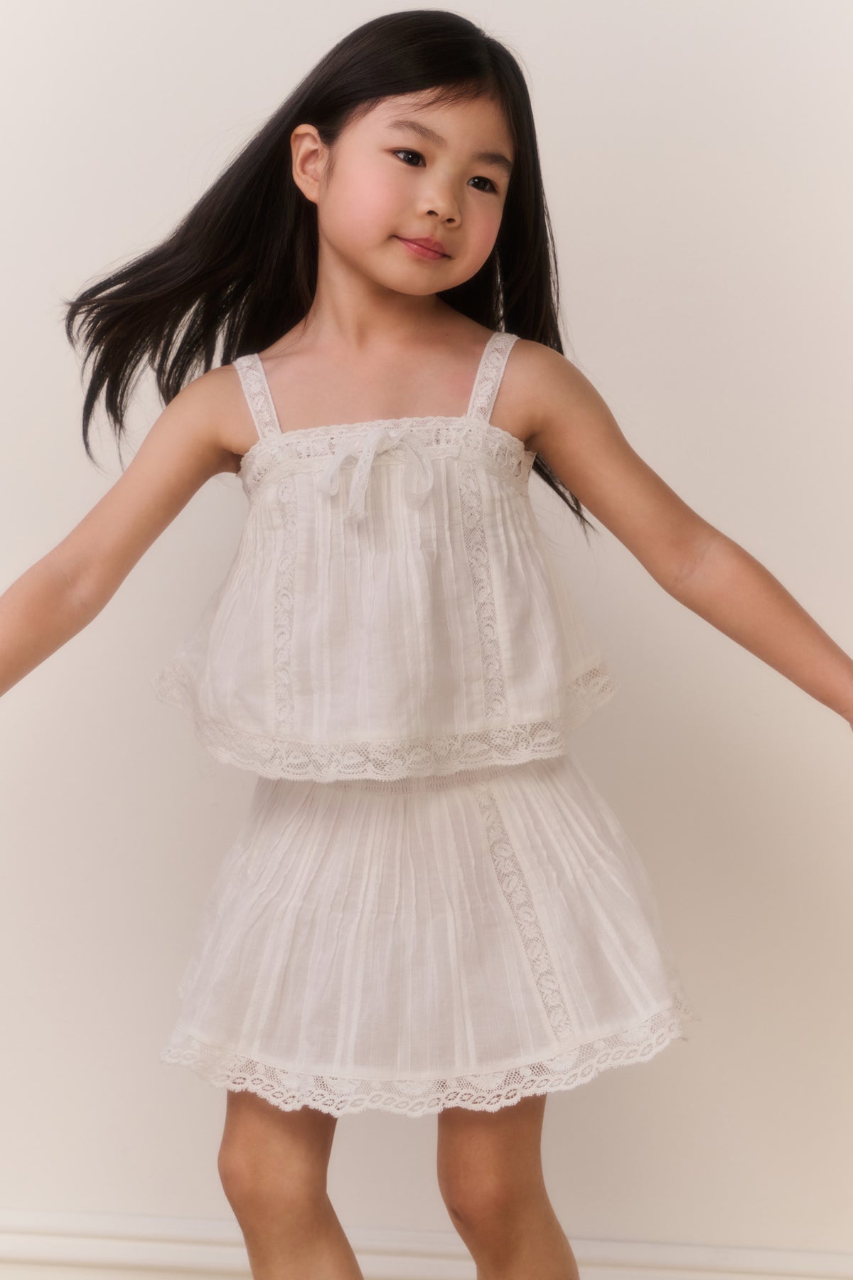 White cotton skirt with layered ruffle tiers and scalloped lace hem