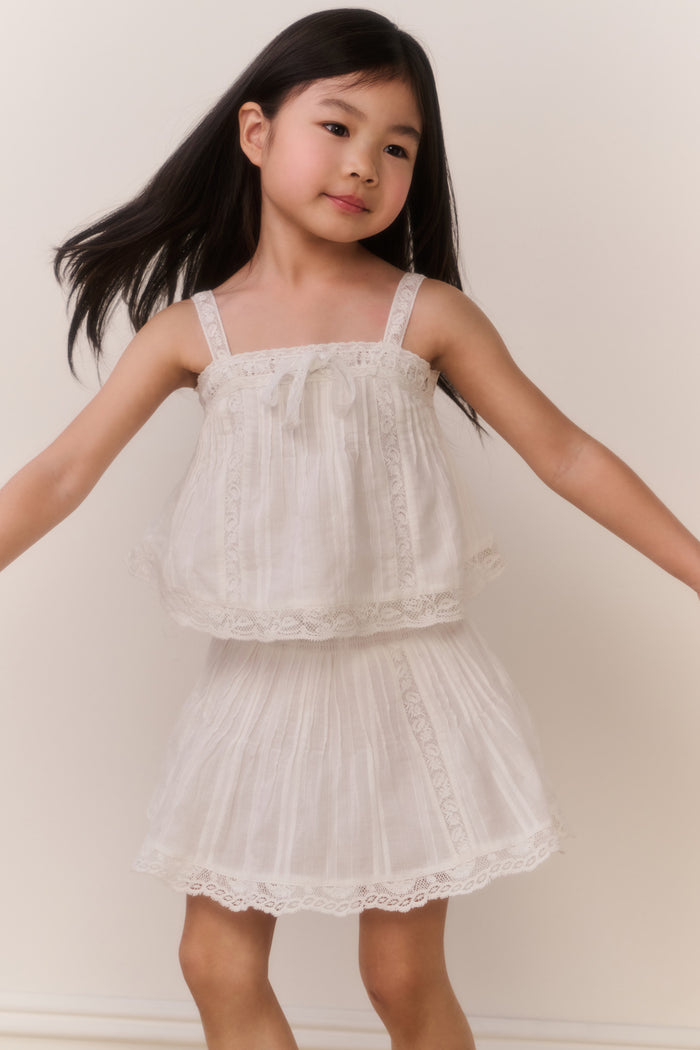 White cotton skirt with layered ruffle tiers and scalloped lace hem