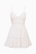 White cotton lace mini dress with spaghetti straps and tiered ruffle skirt