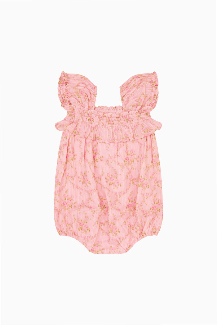 Pink floral baby pinafore with frilled shoulders and gathered skirt front