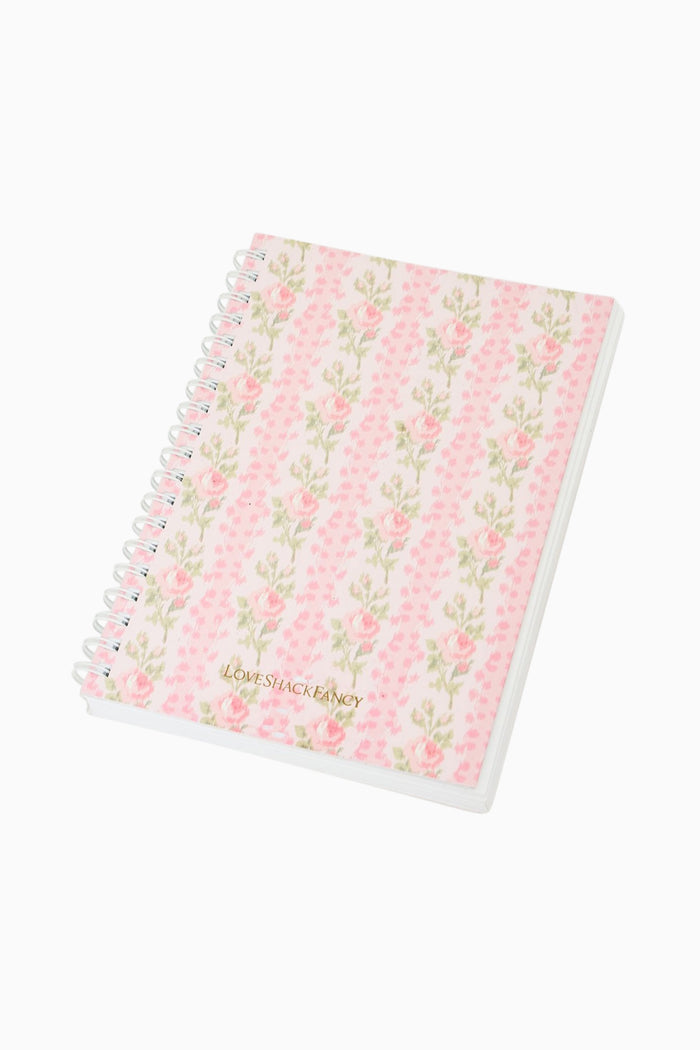 Pink floral spiral notebook with patterned cover and white spiral binding
