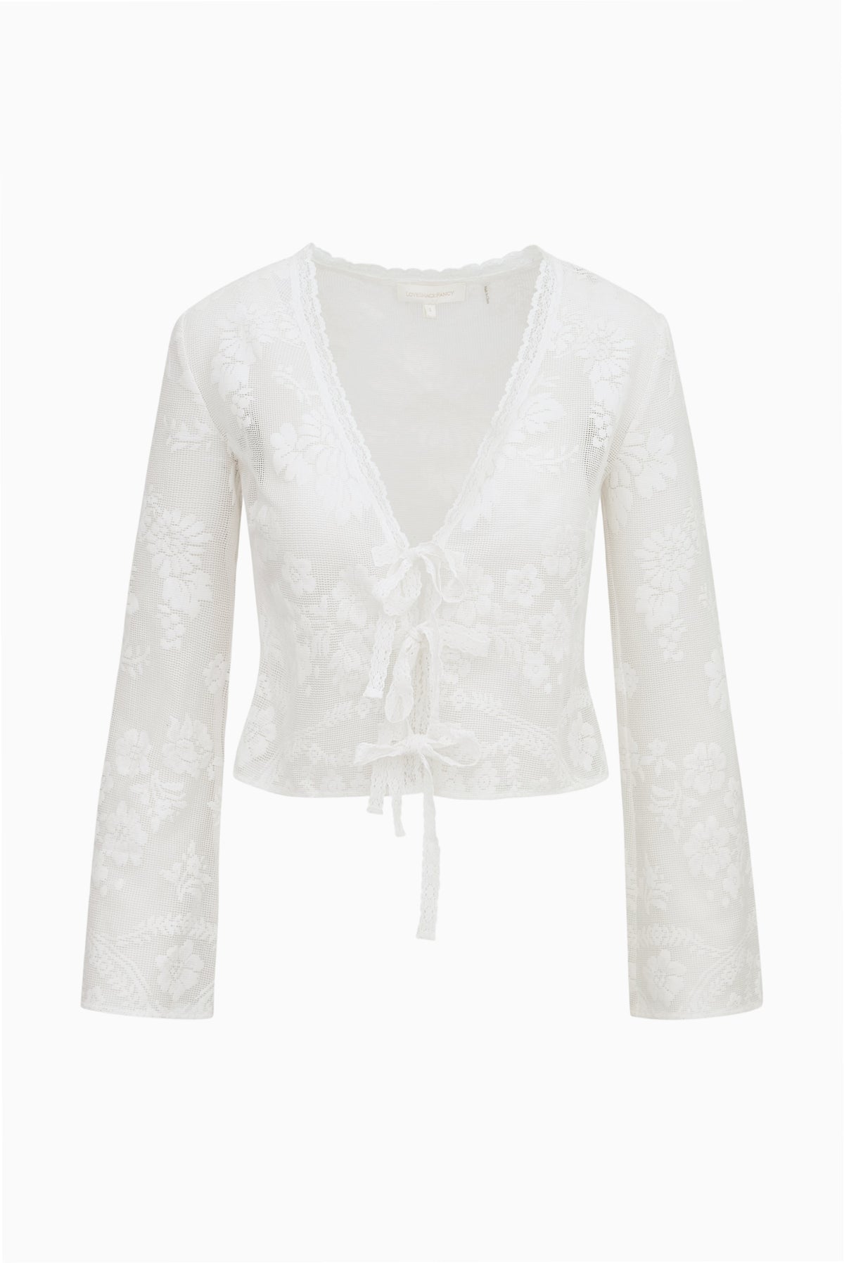 White sheer lace top with V-neck, ruffled trim, long sleeves, center tie tassel