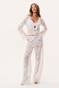 White lace cover-up pants with wide legs and sheer floral print, front stance