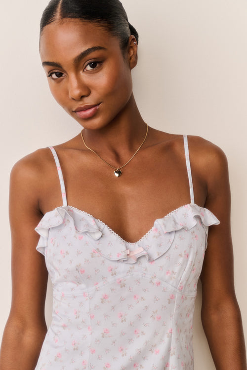 Front view detail of floral cotton mini dress with ruffled bust and thin straps