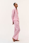 Pink cotton pajama set with button-front shirt and wide-leg pants, side view