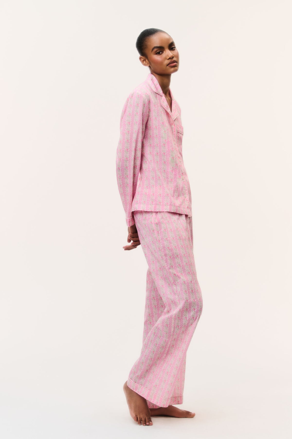 Pink cotton pajama set with button-front shirt and wide-leg pants, side view