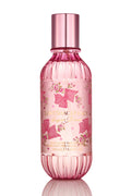 Pink hair and body perfume mist bottle with metallic silver cap, front label visible