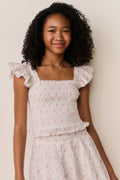 Floral cotton top front view with ruffled cap sleeves and gathered tiered peplum hem