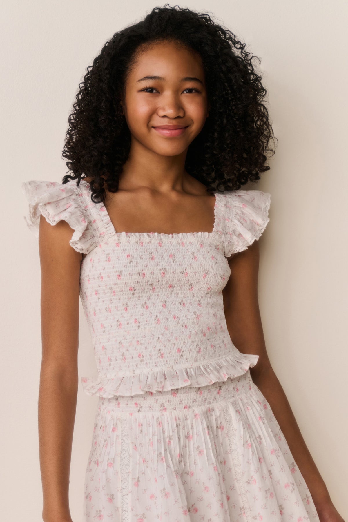 Floral cotton top front view with ruffled cap sleeves and gathered tiered peplum hem