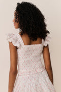 Floral cotton top back view with ruffled cap sleeves and gathered peplum tiers