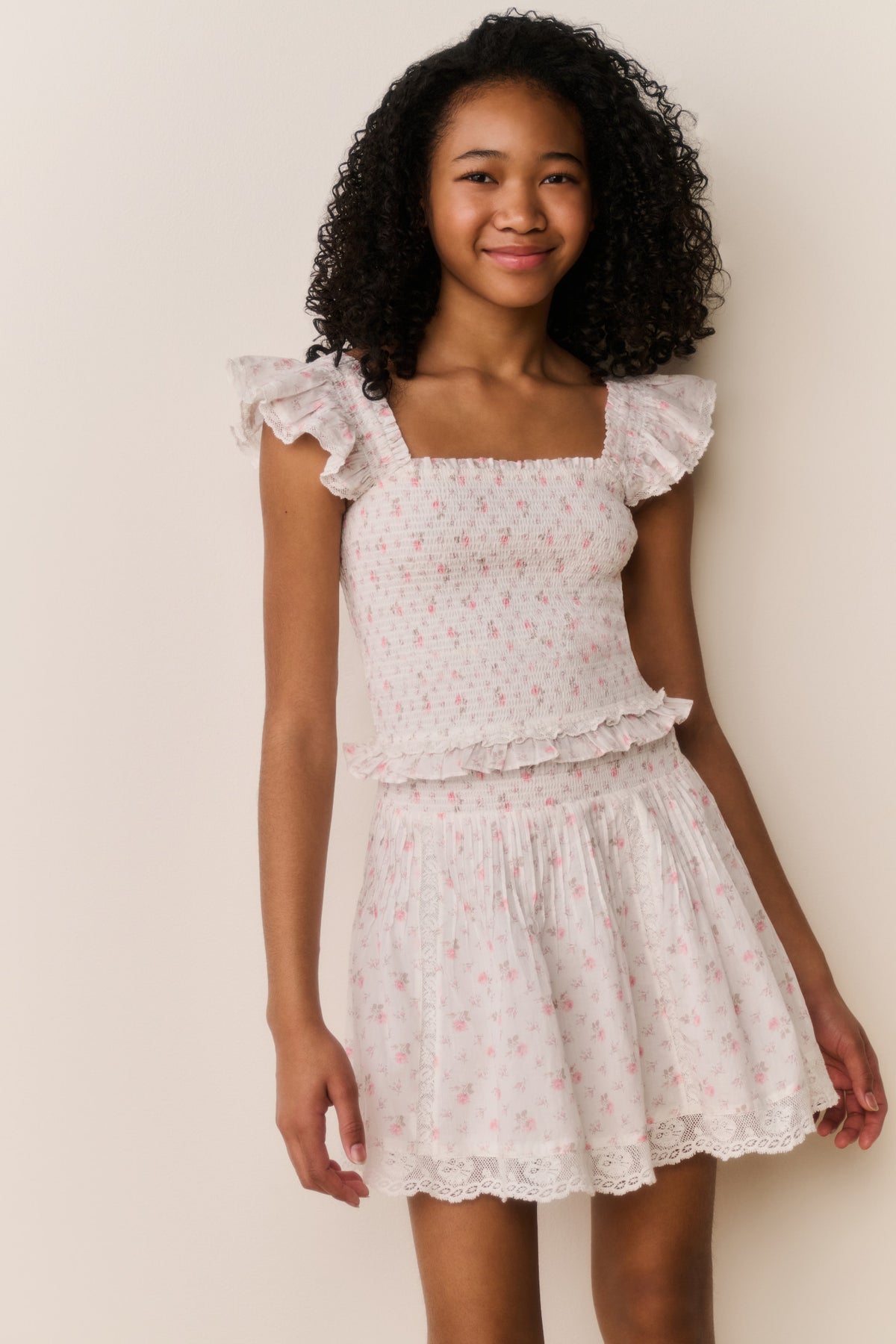 Ivory floral cotton skirt with tiered ruffles and lace-trim hem, front view