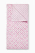 Pink sweetheart quilt with quilted diamond pattern and stitched border