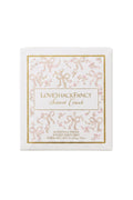 Scented candle box with “LoveShacksFancy Secret Crush” text and pink bow design