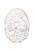 Oval cream vanity set container with gold-trimmed bow motif