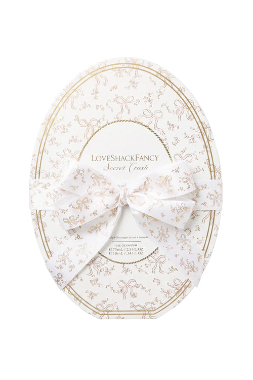 Oval cream vanity set container with gold-trimmed bow motif