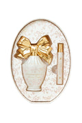 Oval cream perfume set with gold bow and included mini fragrance bottle