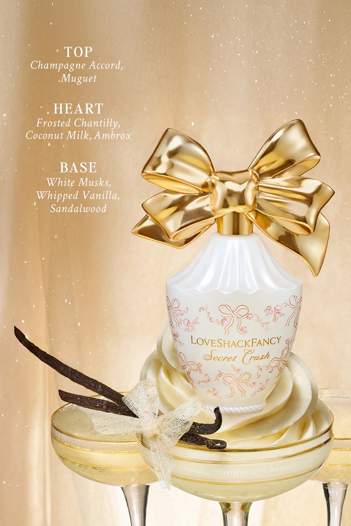 Cream vanity set with gold bow, perfume bottle, and candle in a decorative tray