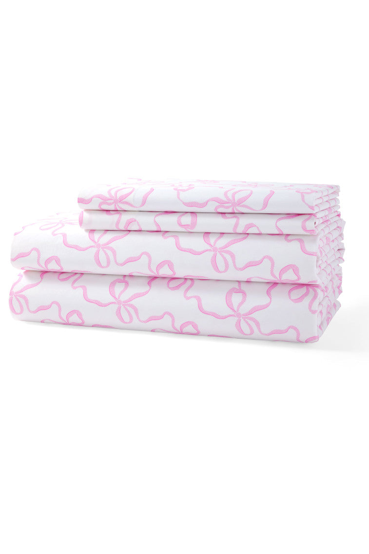 Pink printed cotton sheet set, neatly folded with bow all-over pattern