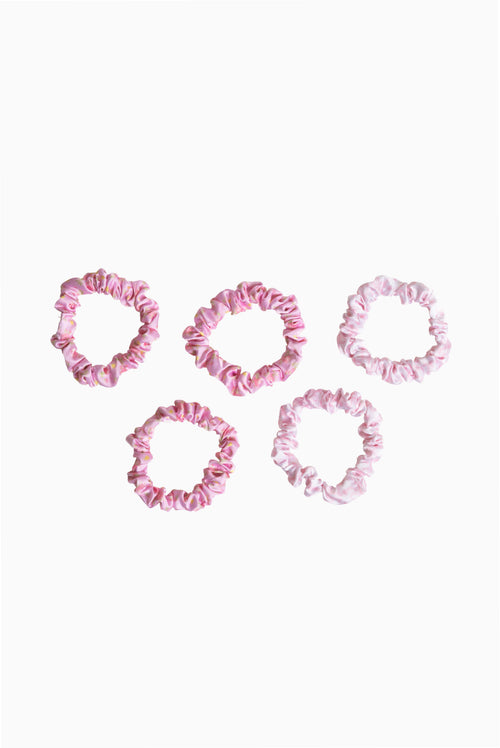 Five pink satin scrunchies with gathered ruffled texture