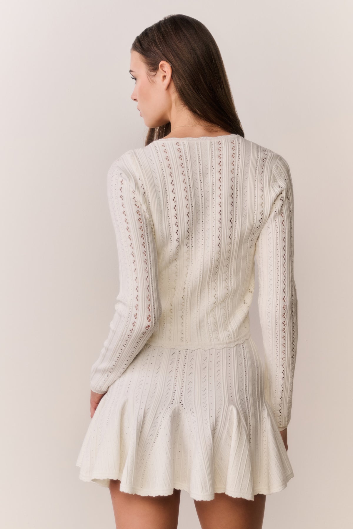 White pointelle stretch cardigan back view with long sleeves and vertical knit detailing