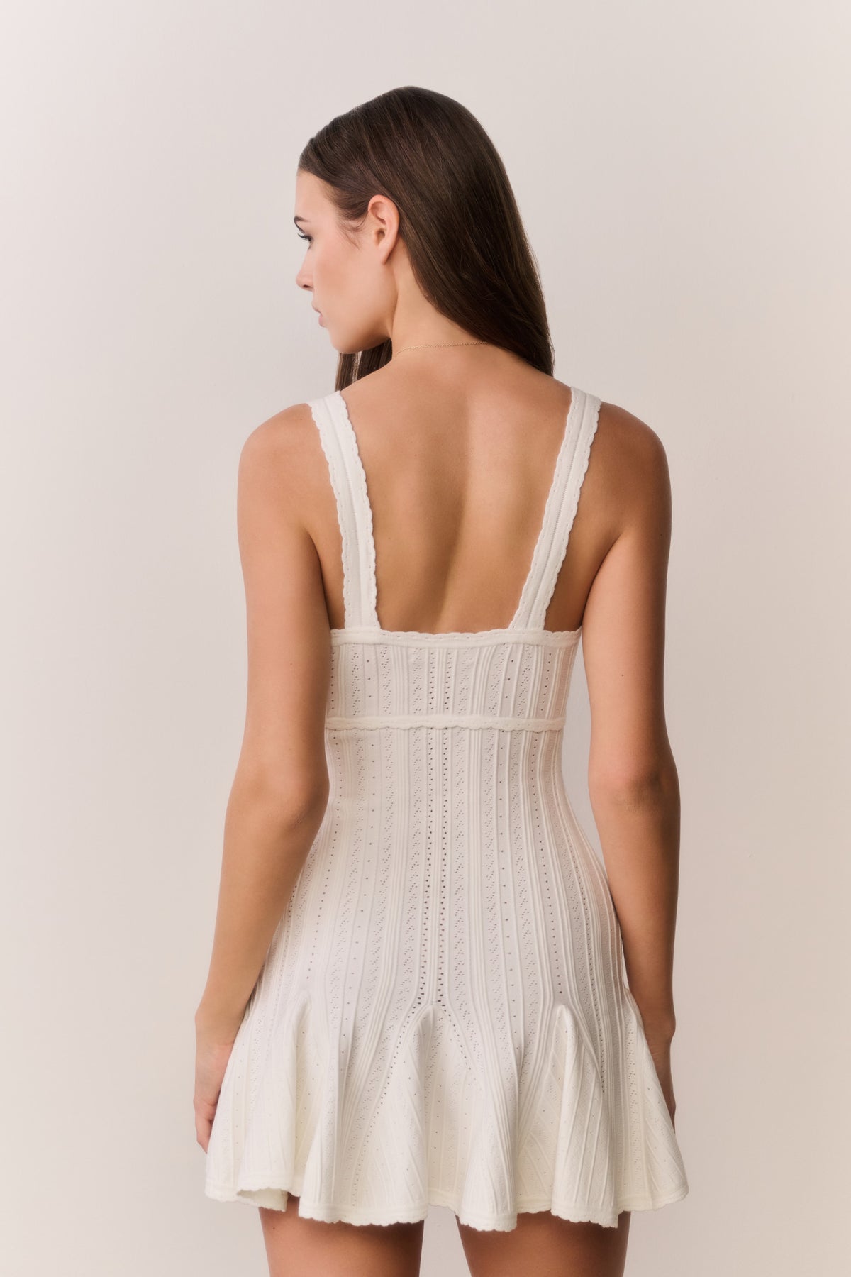 White pointelle mini dress back view with wide straps and flared mini hem