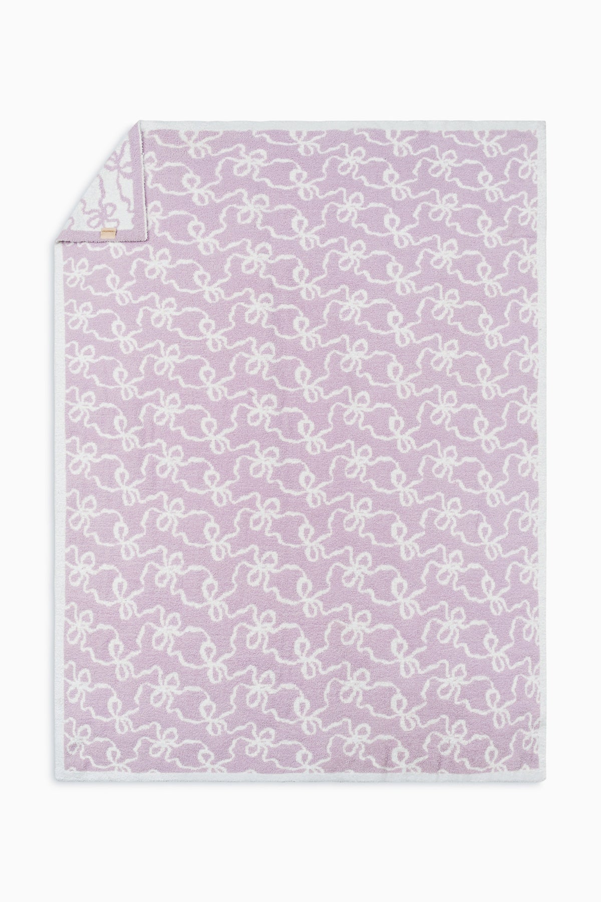 Light purple teddy bow blanket with allover white bow pattern and stitched border