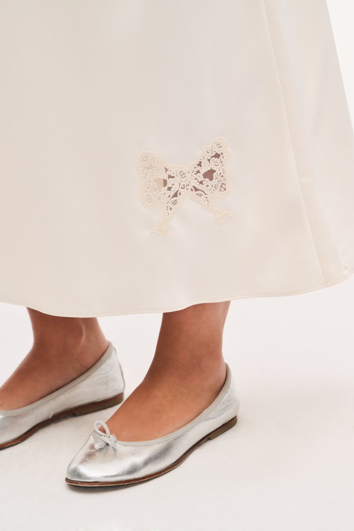 Ivory crepe maxi skirt hem with embroidered lace applique