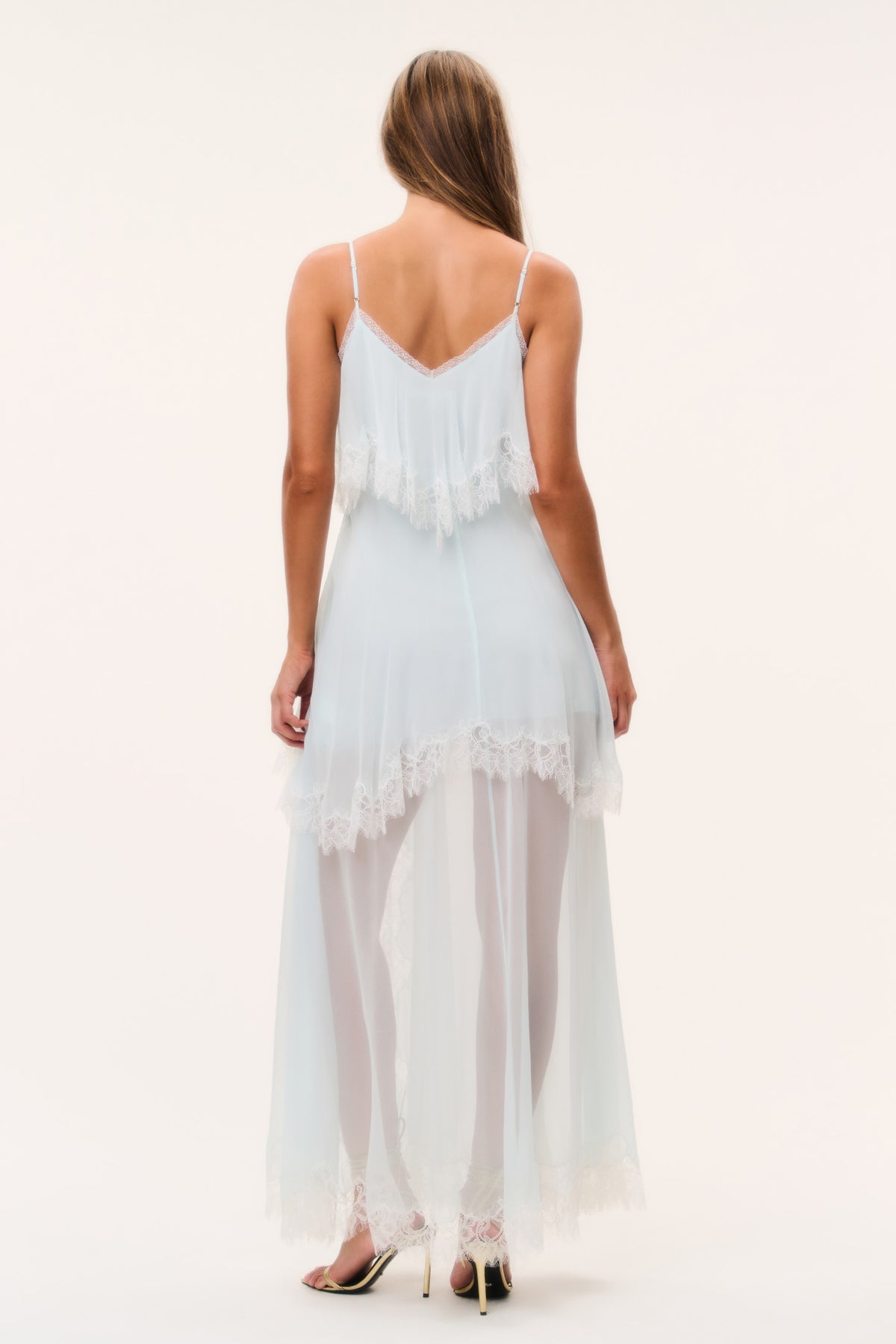 Light aqua silk chiffon maxi dress with open back straps, lace hem, and layered ruffle skirt.