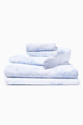 Cotton bath towel, light blue, folded stack of 3 with plush terry loops.