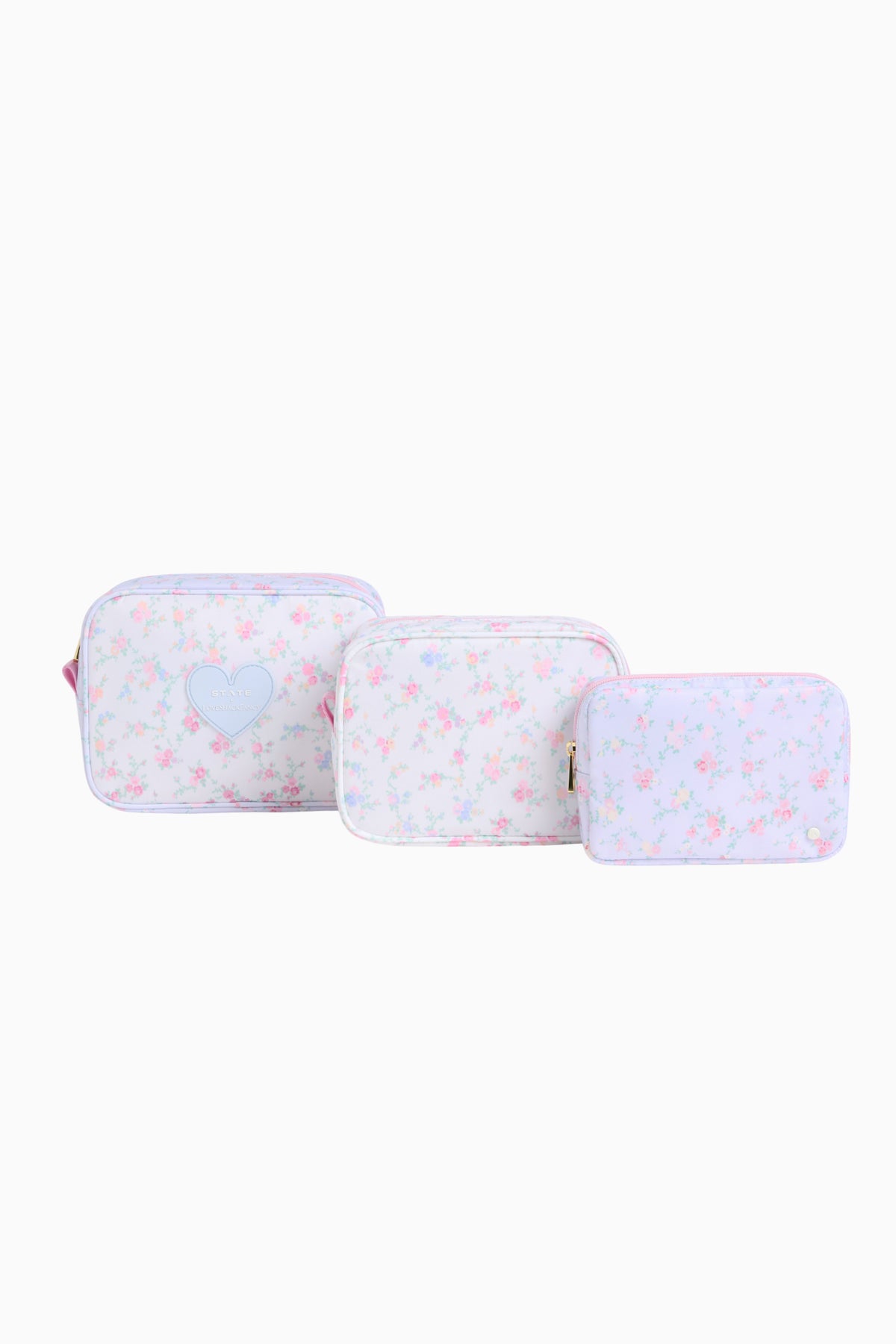 Floral travel pouches set: three zippered rectangular pouches with light pink flower print