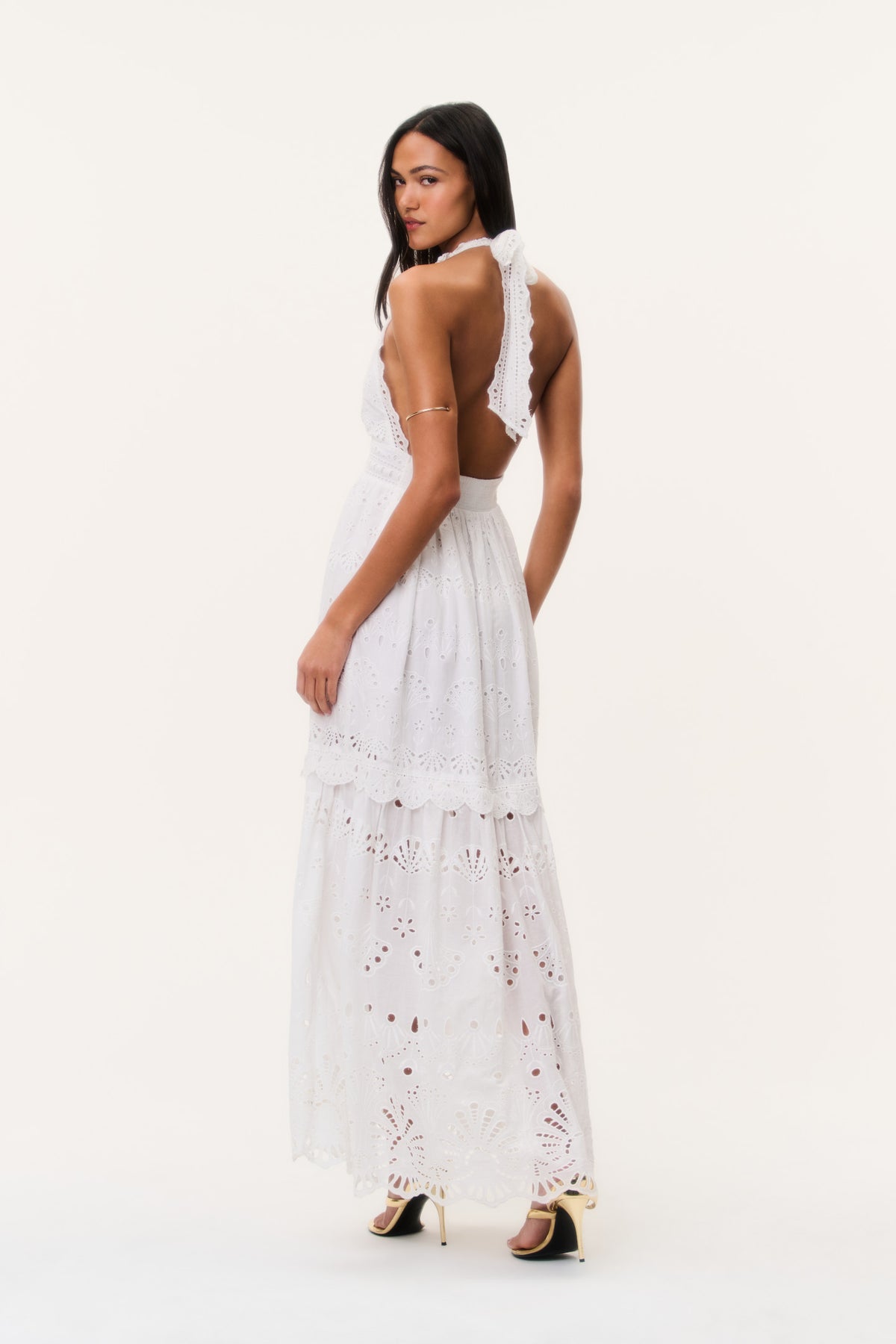 Optic white eyelet halter maxi dress from back view with open back and layered hem