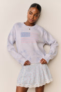 Light blue knit pullover with flag graphic, crew neck, ribbed hem