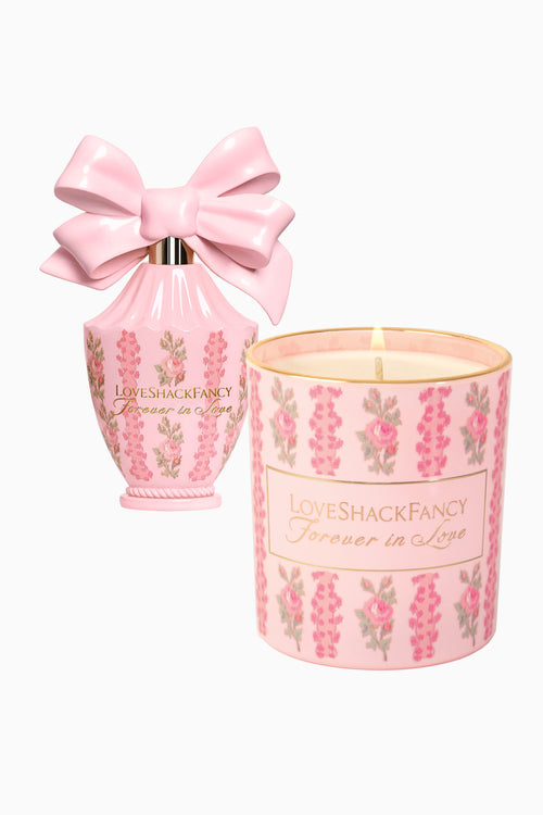 Pink floral candle jar with LoveShackFancy label, plus pink satin bow gift pouch