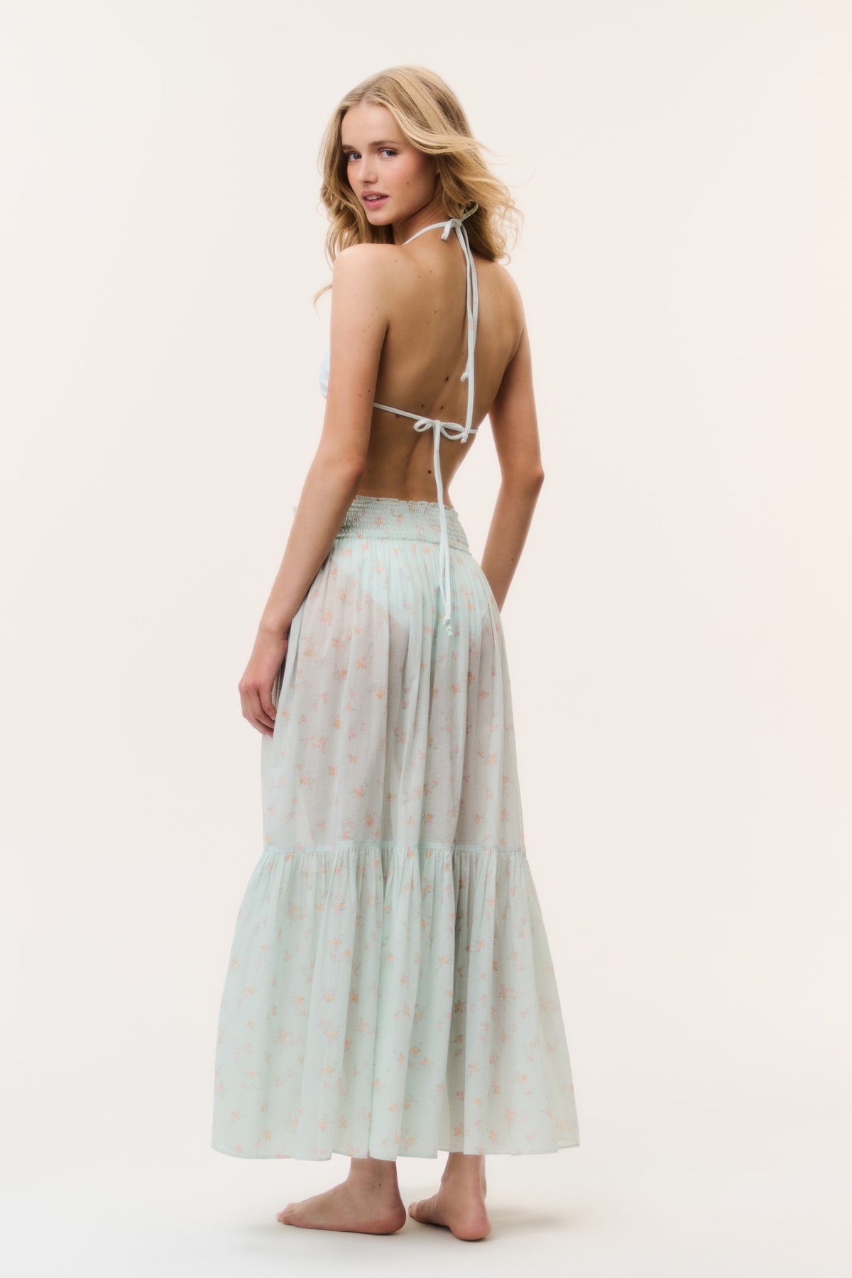 Umber cotton cover-up skirt in light celadon with small pattern, tiered maxi from back.