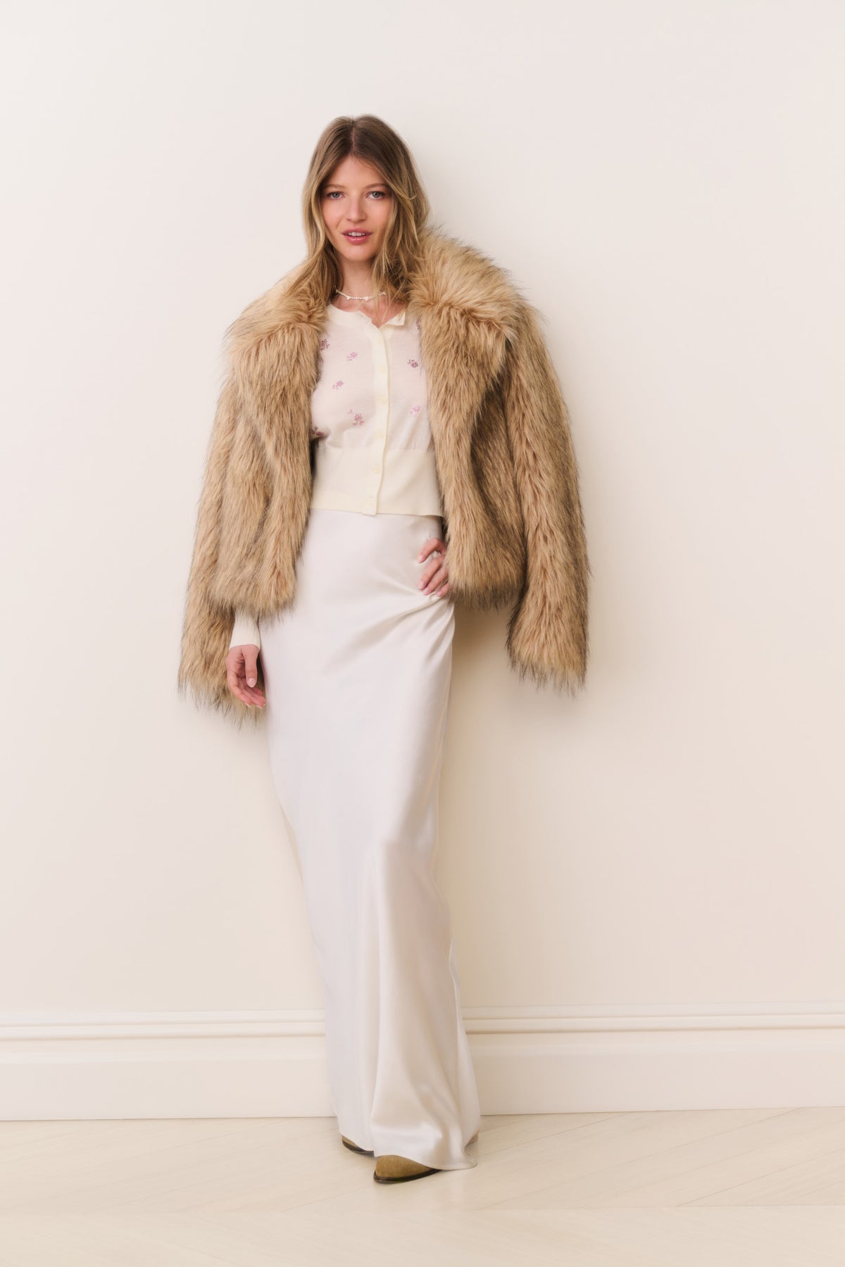 Faux fur jacket in burnt caramel, open-front shaggy style with long sleeves.