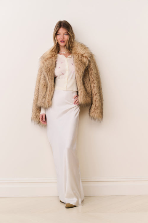 Faux fur jacket in burnt caramel, open-front shaggy style with long sleeves.