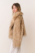 Faux fur jacket in burnt caramel, side view with high plush collar and long sleeves.