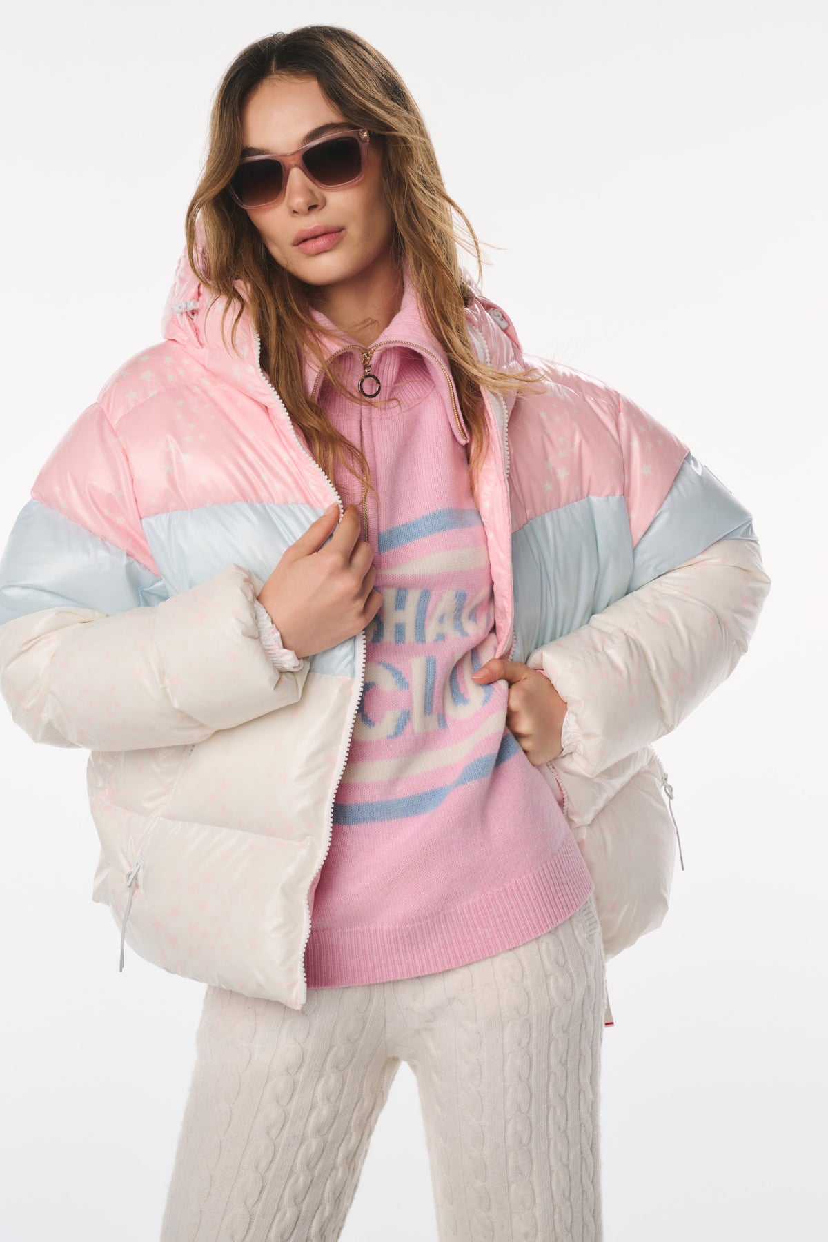 Puffer jacket with pink quilted hood, light blue panels, and faux-fur trimmed cuffs.
