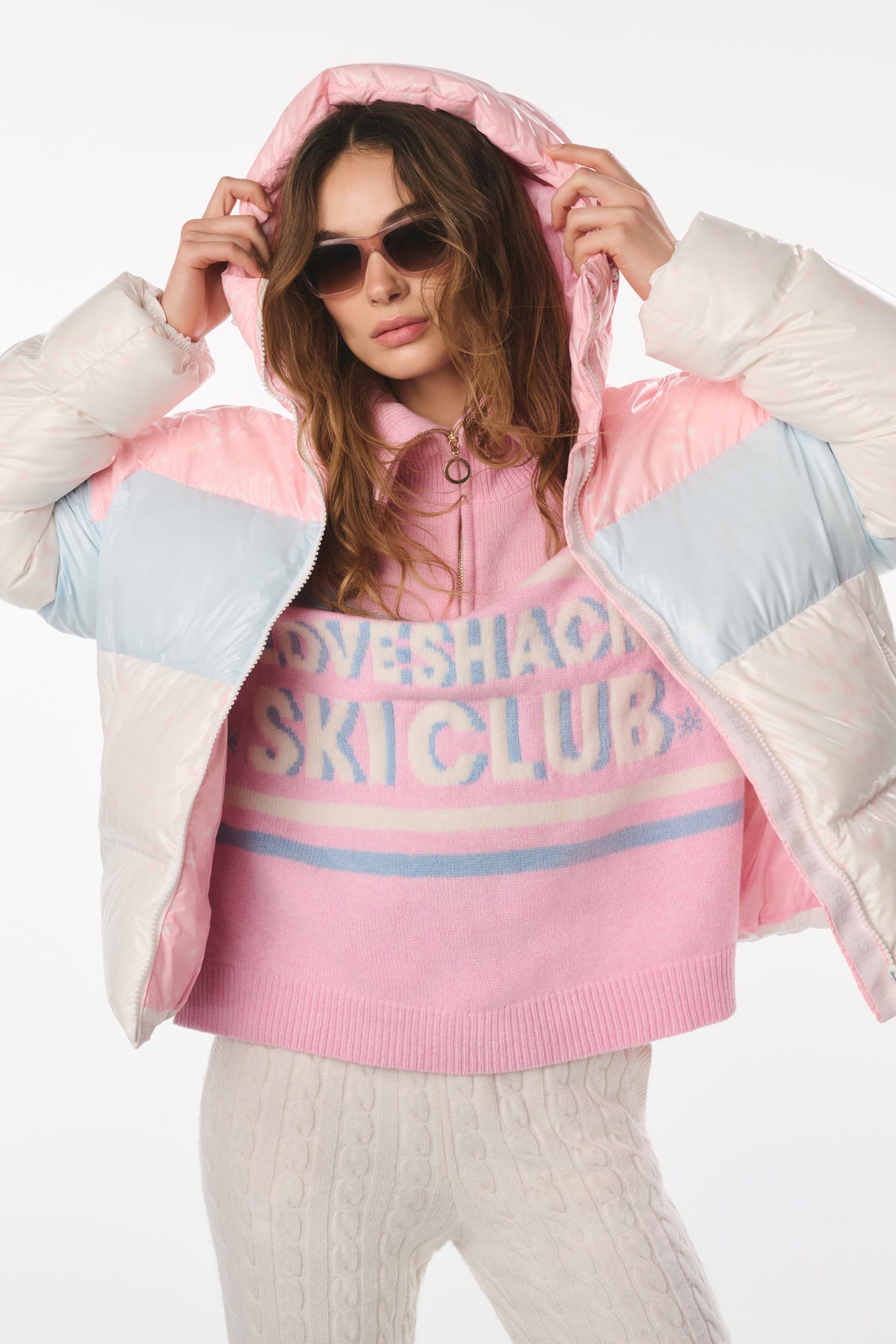 Hooded puffer jacket with pink-and-light-blue panels and faux-fur cuffs.