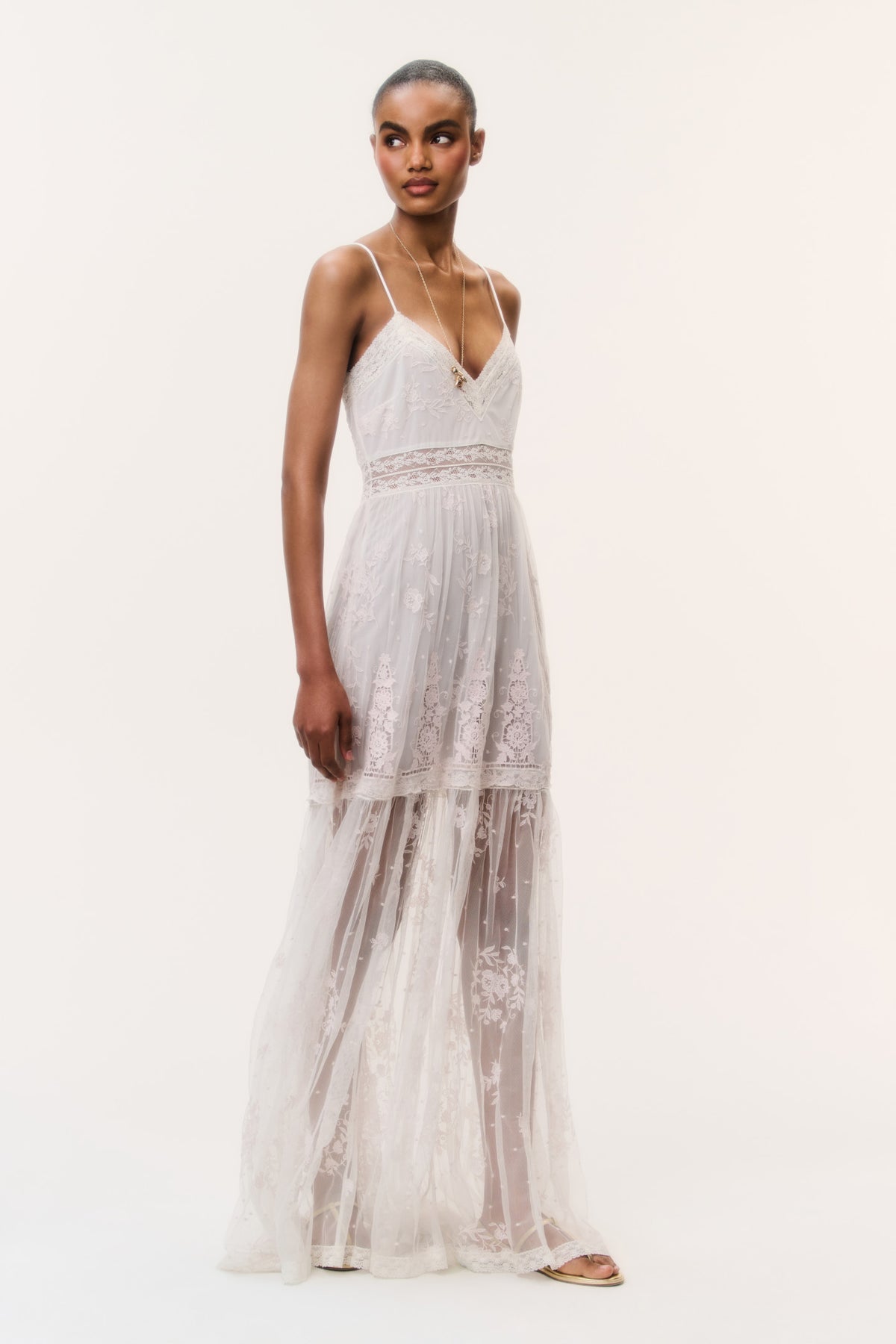 Ivory embroidered tulle maxi dress with spaghetti straps and tiered lace panels