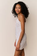 Side view floral cotton mini dress with thin straps and light pink flower print