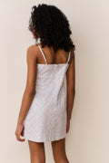 Back view floral cotton mini dress with spaghetti straps and small pink flower print