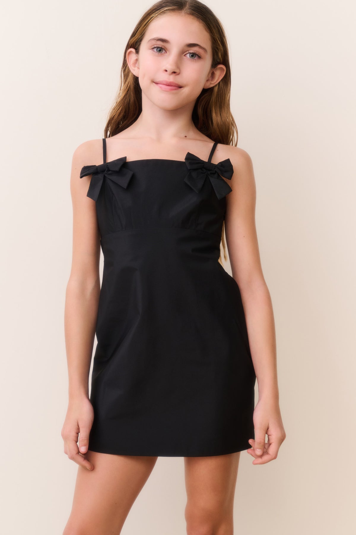 Black bow mini dress with spaghetti straps and two shoulder bows