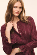 Faded merlot cotton Swiss dot mini dress with buttoned neckline and long ruffled sleeves