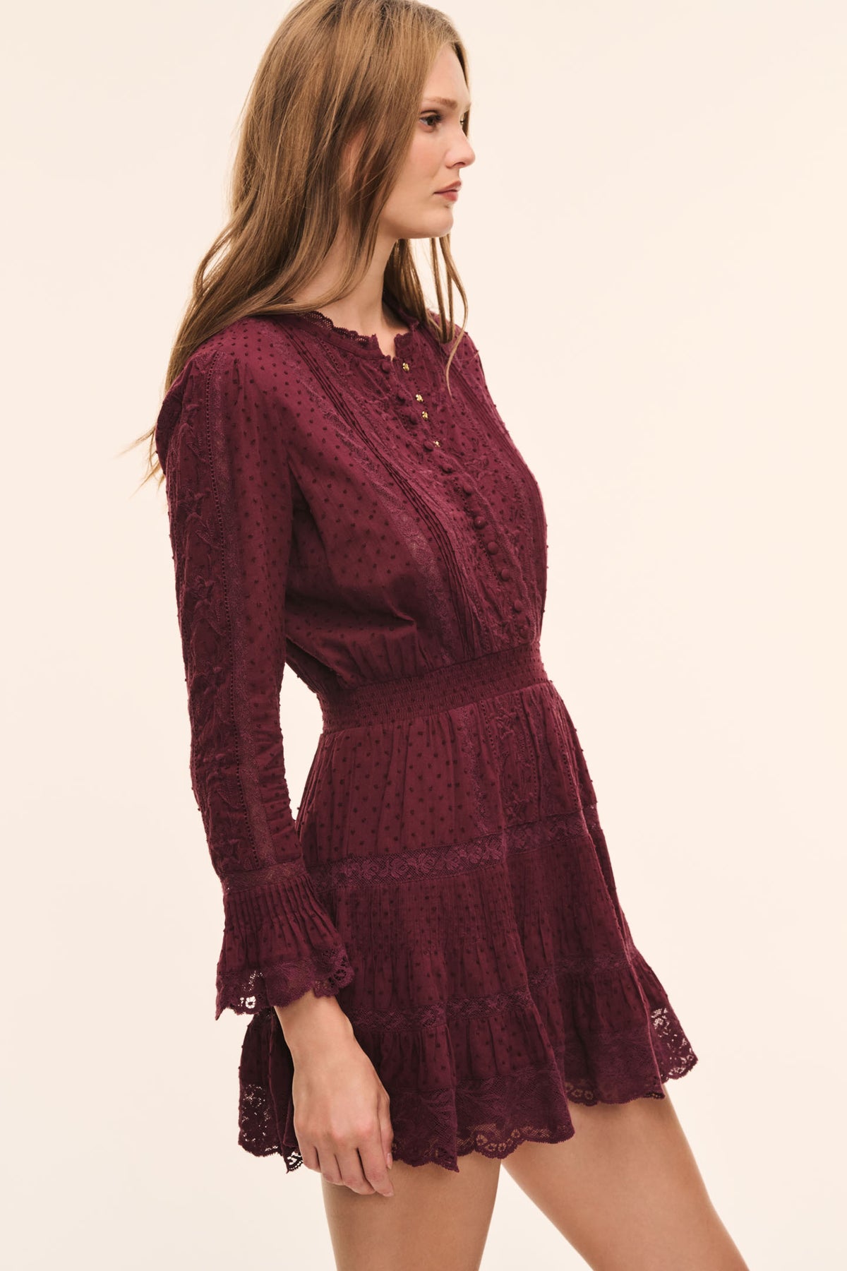 Faded merlot cotton Swiss dot mini dress with long sleeves and tiered ruffle hem