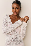 Cream crochet mini cover-up dress with scalloped V-neck and long sleeves, close-up