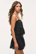 Black lace camisole top with thin straps and layered ruffle hem